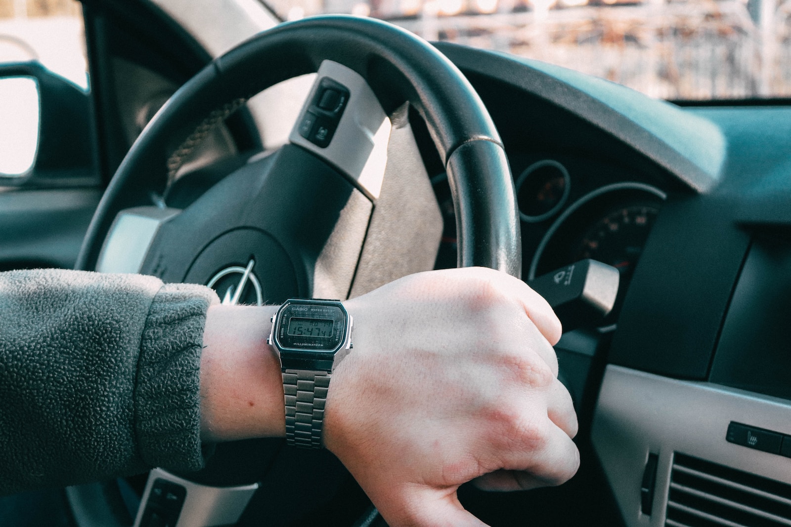 a person holding a steering wheel