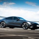 blue coupe on gray asphalt road during daytime