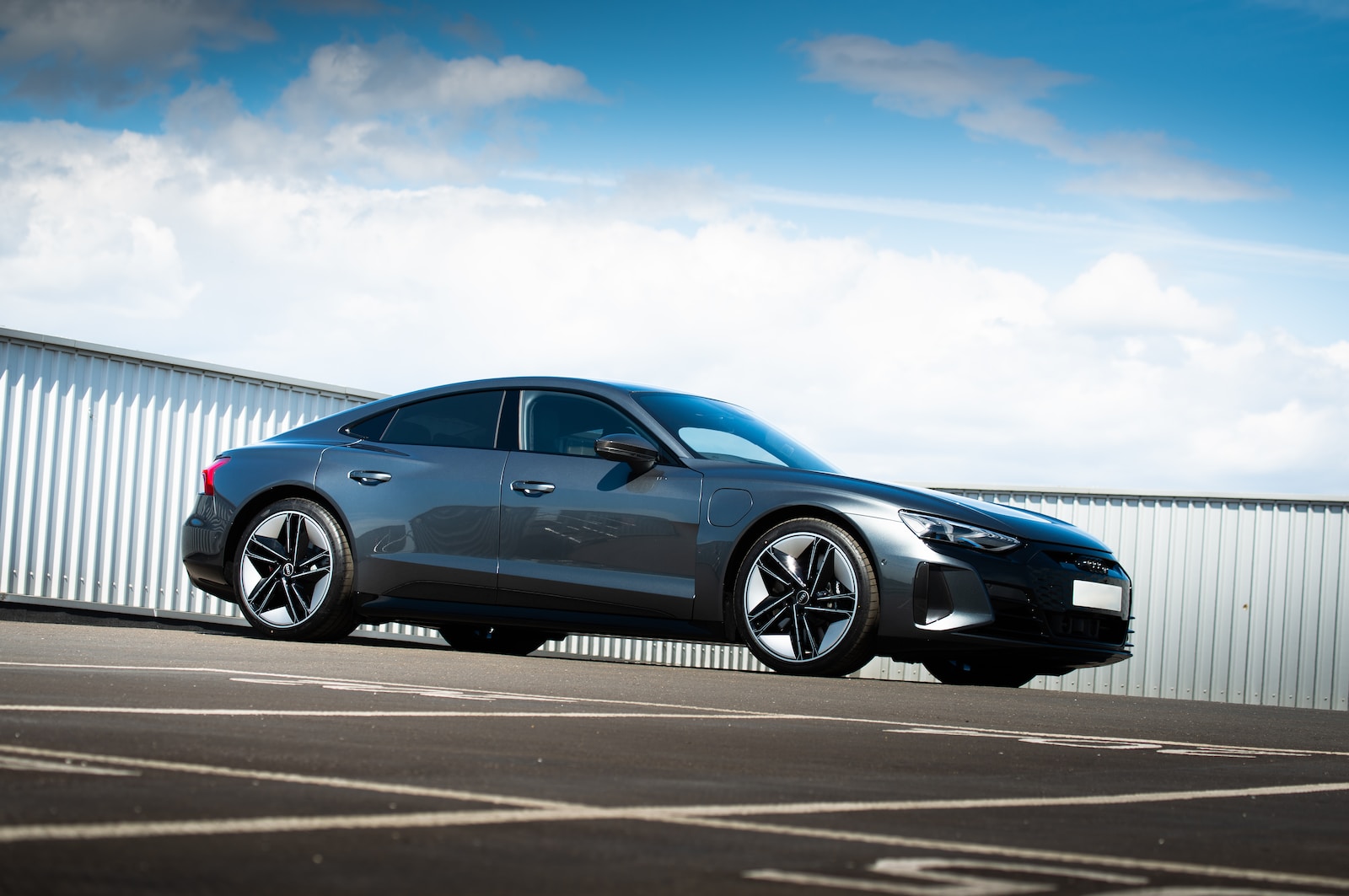 blue coupe on gray asphalt road during daytime