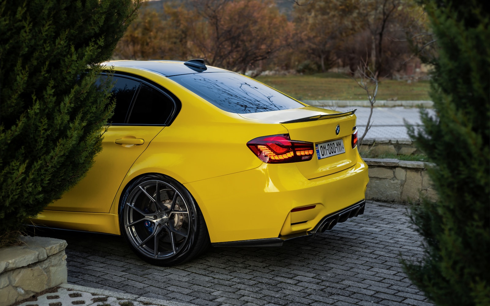 a yellow car is parked in a driveway