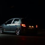 a car parked on the side of the road at night