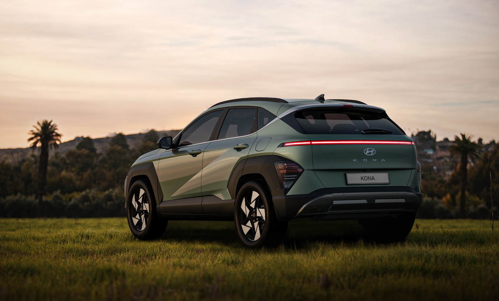 a green suv parked in a grassy field