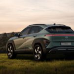 a green suv parked in a grassy field