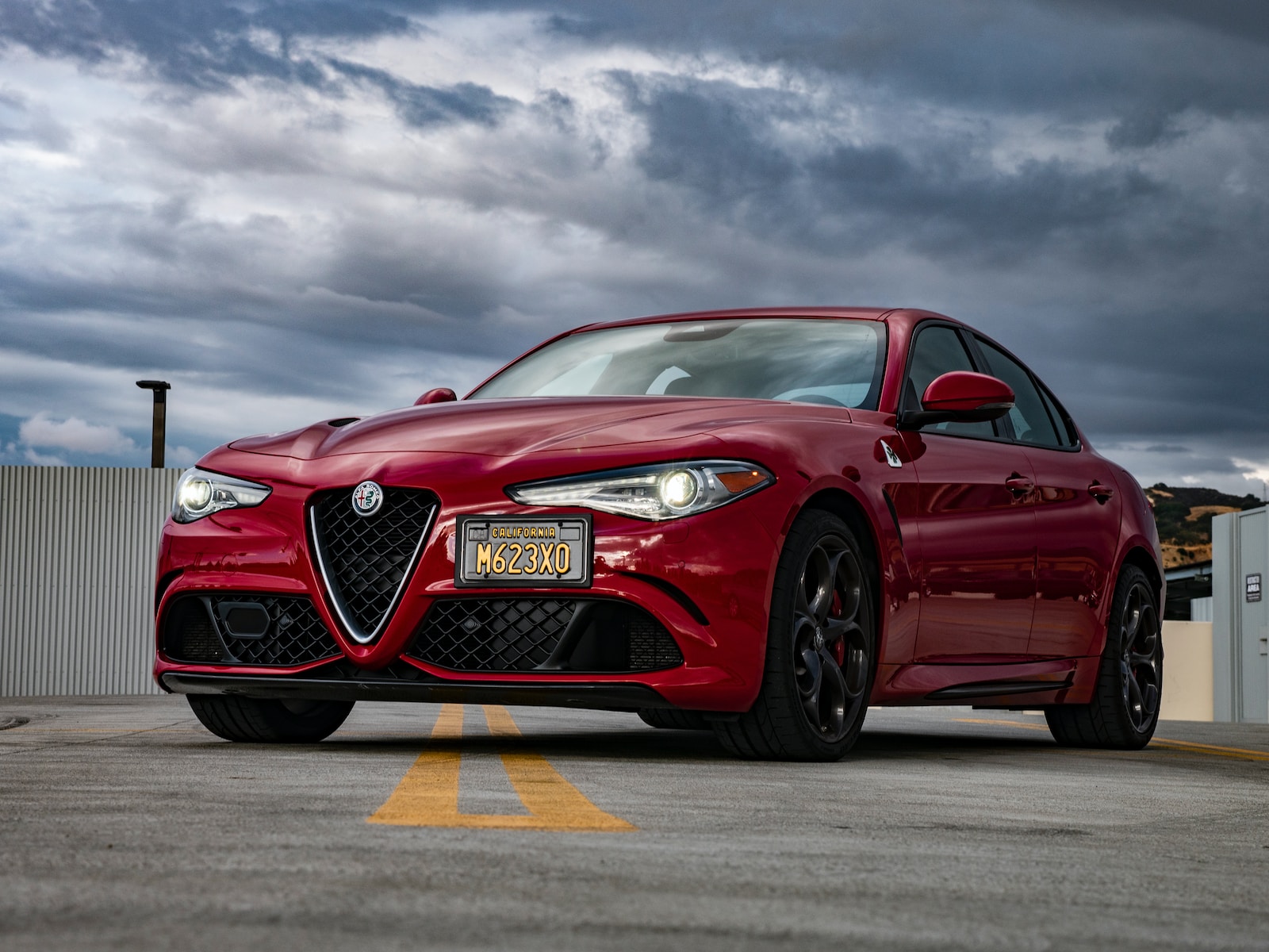 selective focus photography of parked red sedan