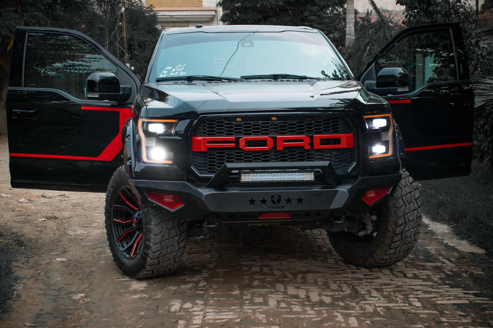 a black truck with red lettering parked in front of a house