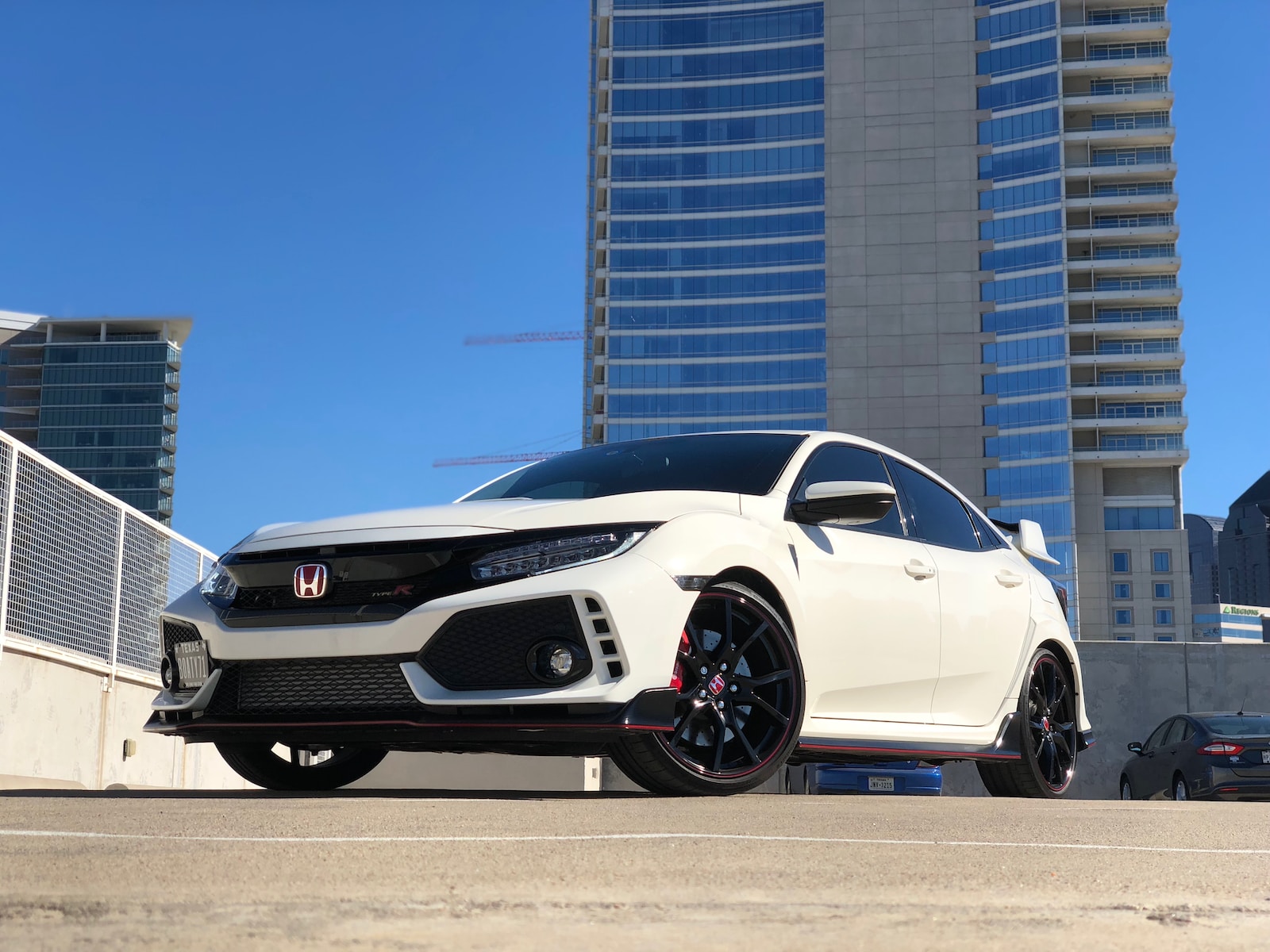 white Honda car parked near building