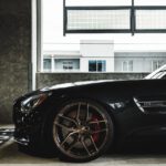 black car parked in front of white building