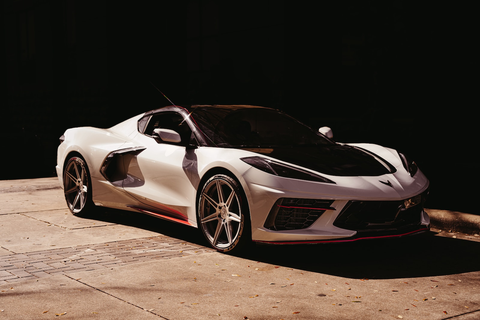 white lamborghini aventador in a dark room