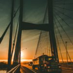 brown Maek freight truck on bridge during dawn