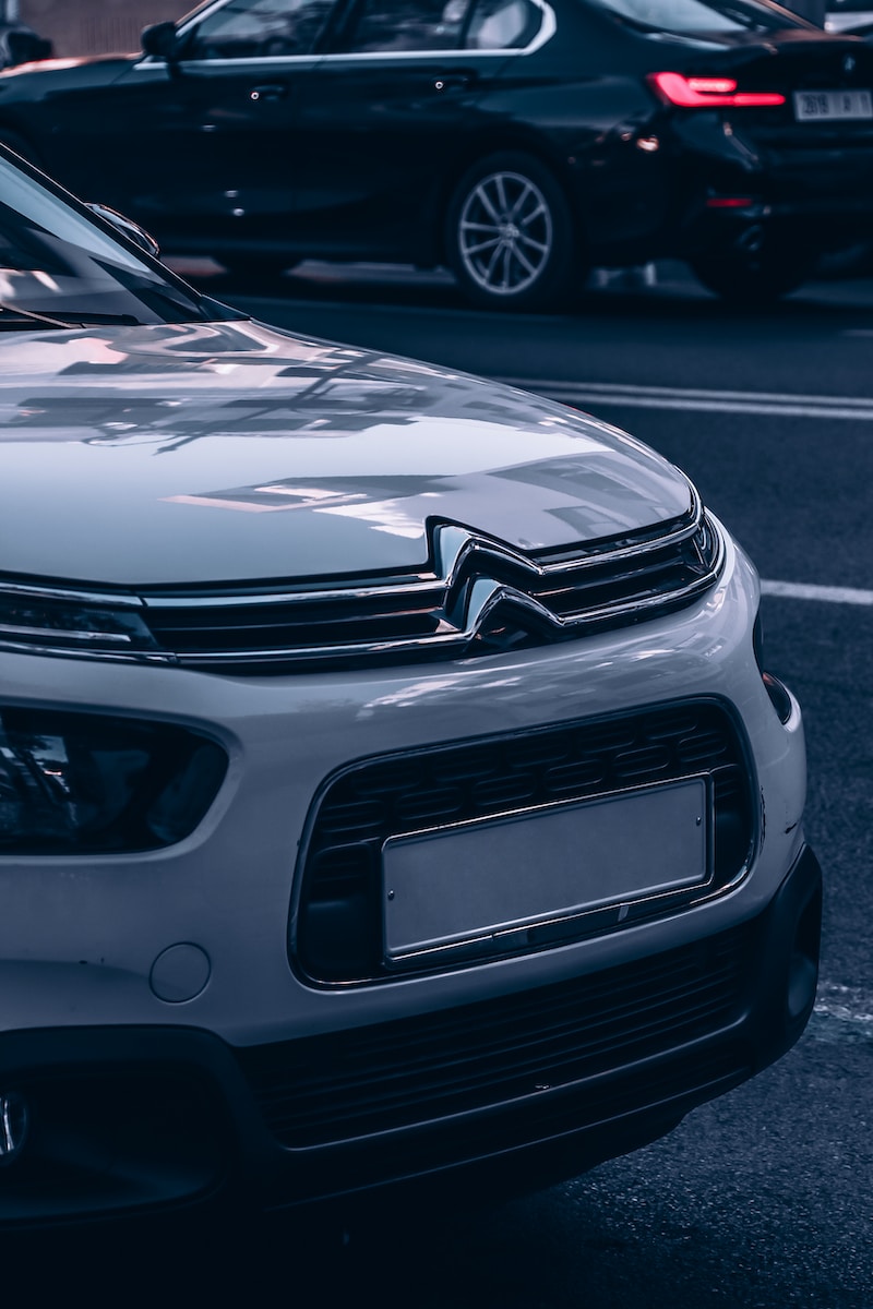 white and black car on road during daytime