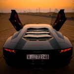 closeup photo of gray coupe on desert