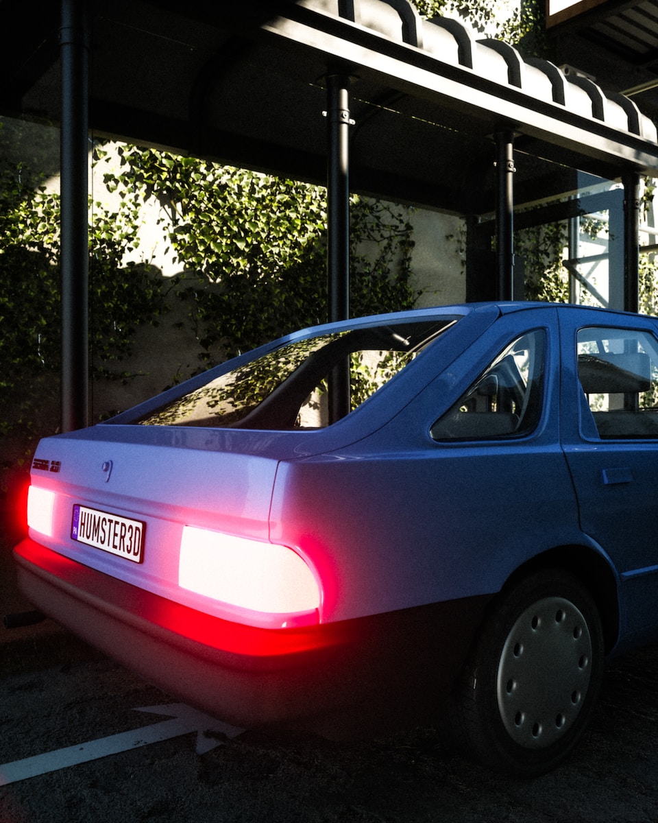 a blue car parked in a parking lot next to a building