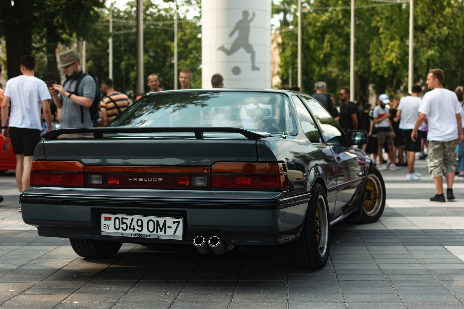 a car parked in front of a crowd of people