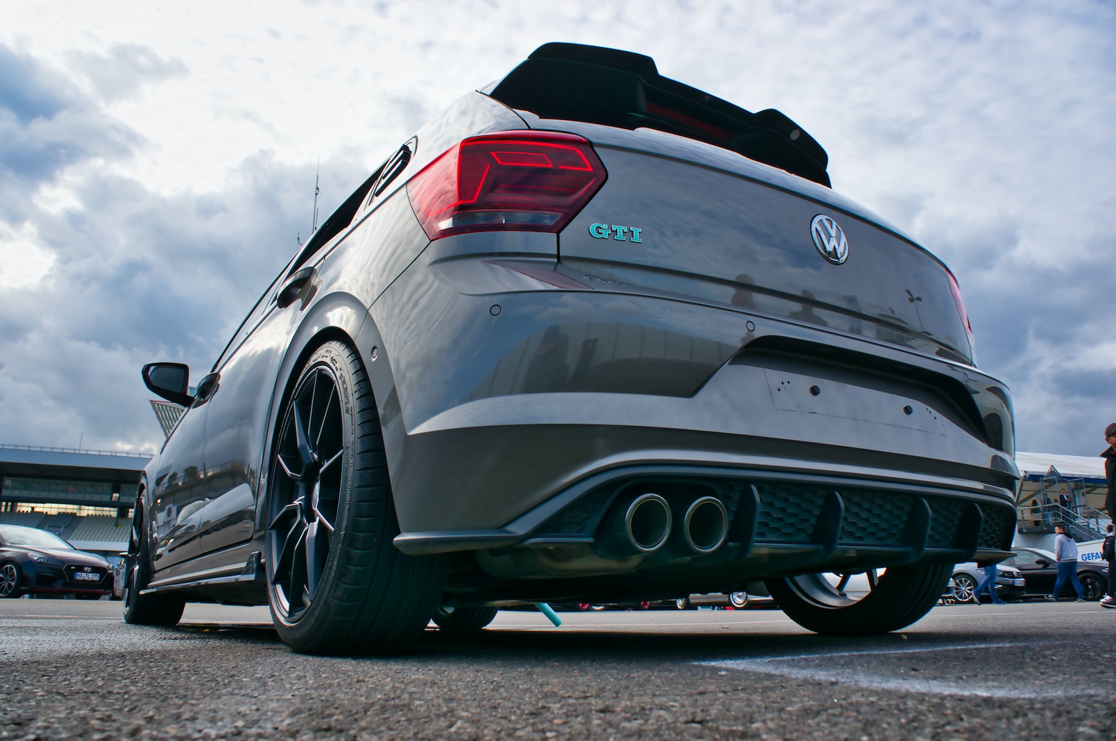 the rear end of a car parked in a parking lot