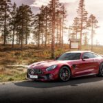 red Mercedes-Benz coupe on road