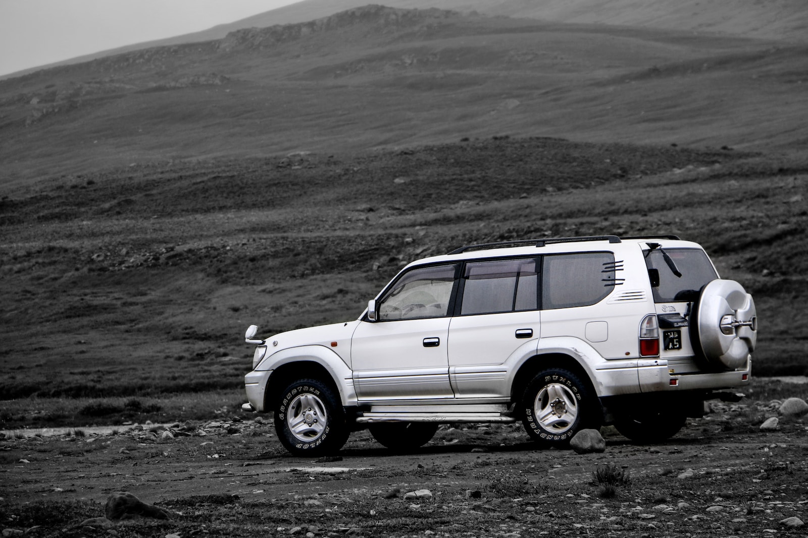 white suv on dirt road