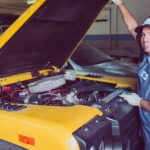 man holding open-wide car trunk