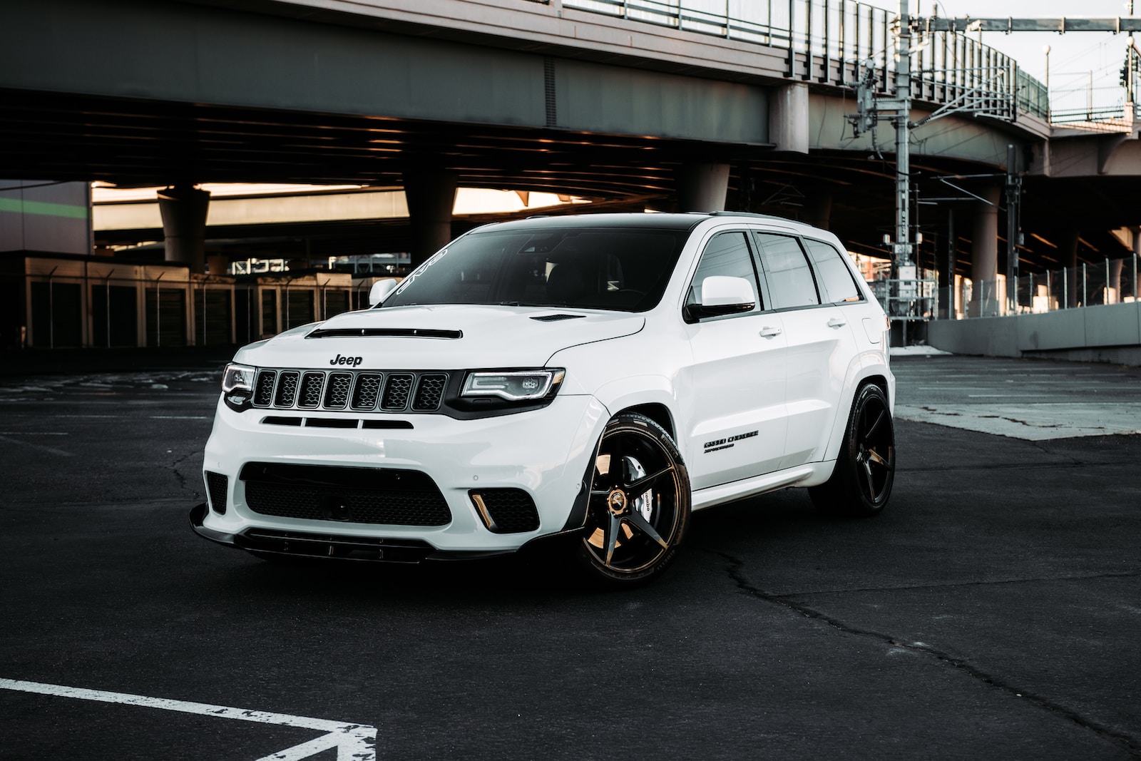 white bmw x 6 parked on parking lot during daytime