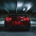 red sports car on concrete flooring