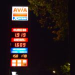 a gas station sign lit up at night