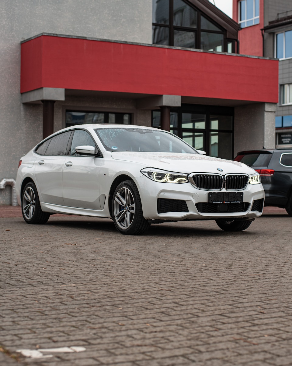 a white car parked in front of a building