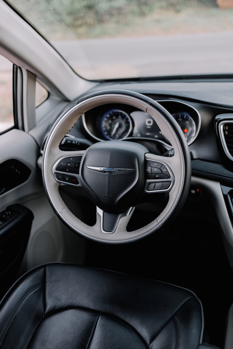 the interior of a car with a steering wheel and dashboard