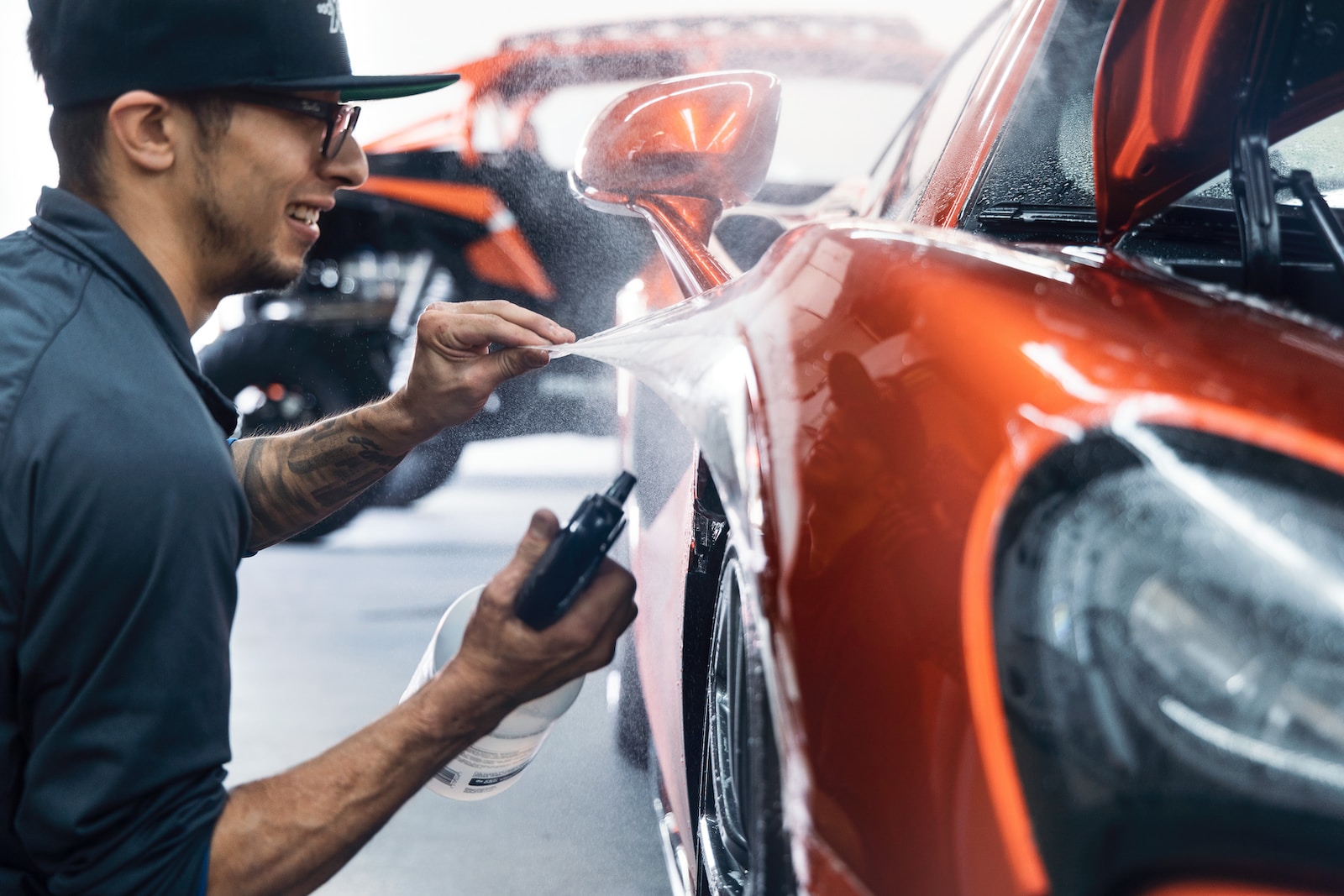 a man waxing a car in a garage