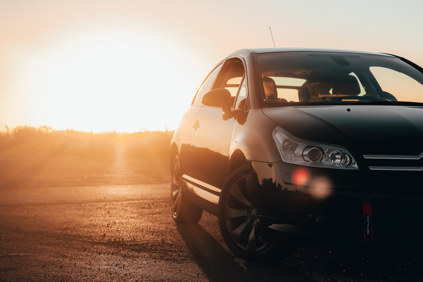 black volkswagen golf on road during sunset