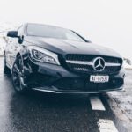 black Mercedes-Benz car on grey concrete surface