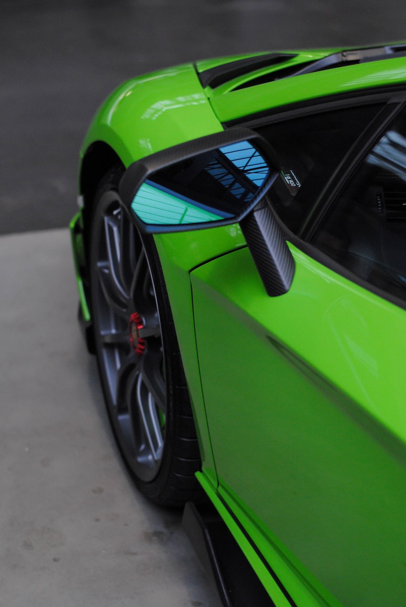 green and black car on road during daytime