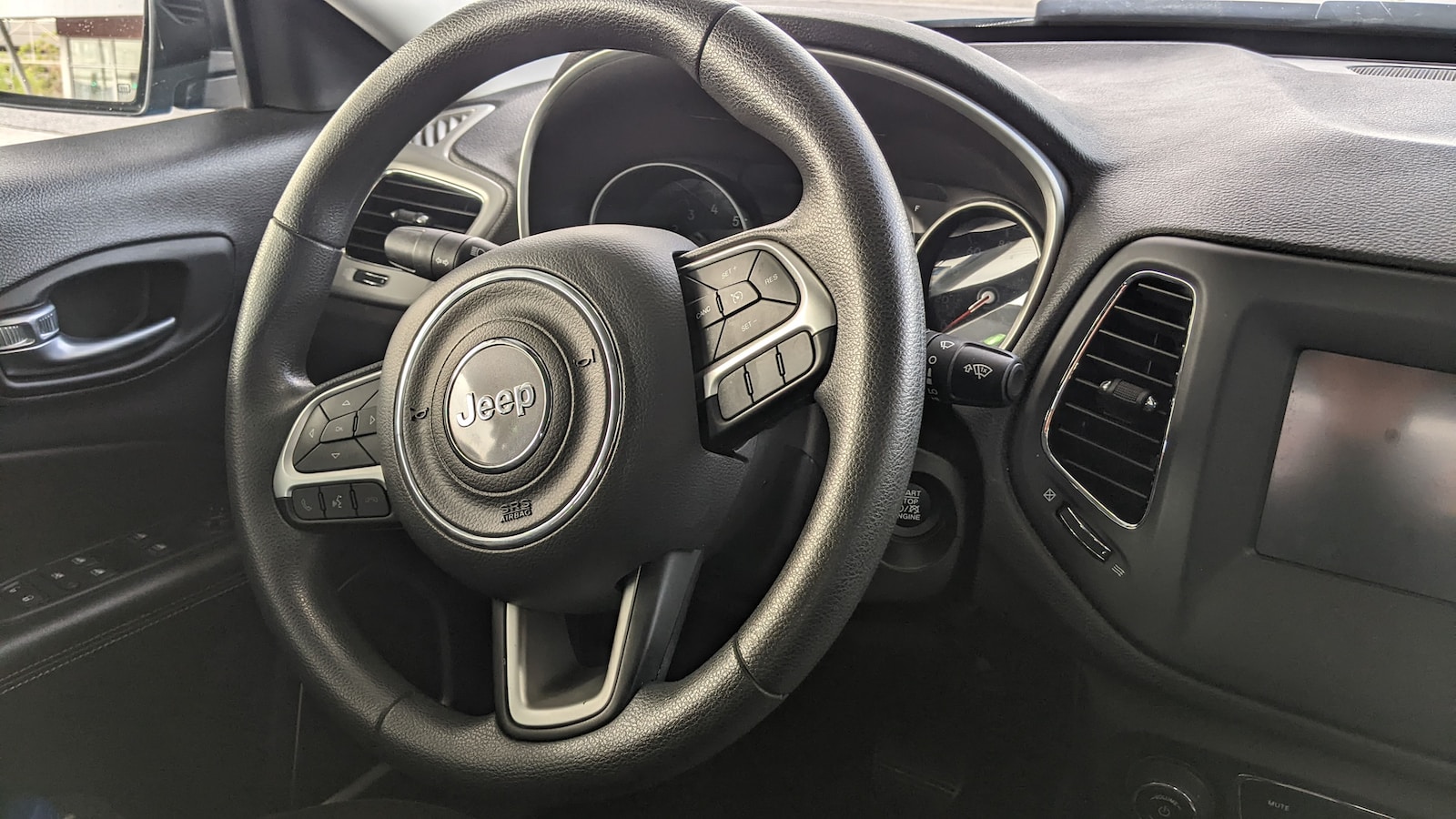 the steering wheel and dashboard of a car