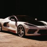 white lamborghini aventador in a dark room