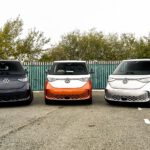 three electric vehicles parked in a parking lot