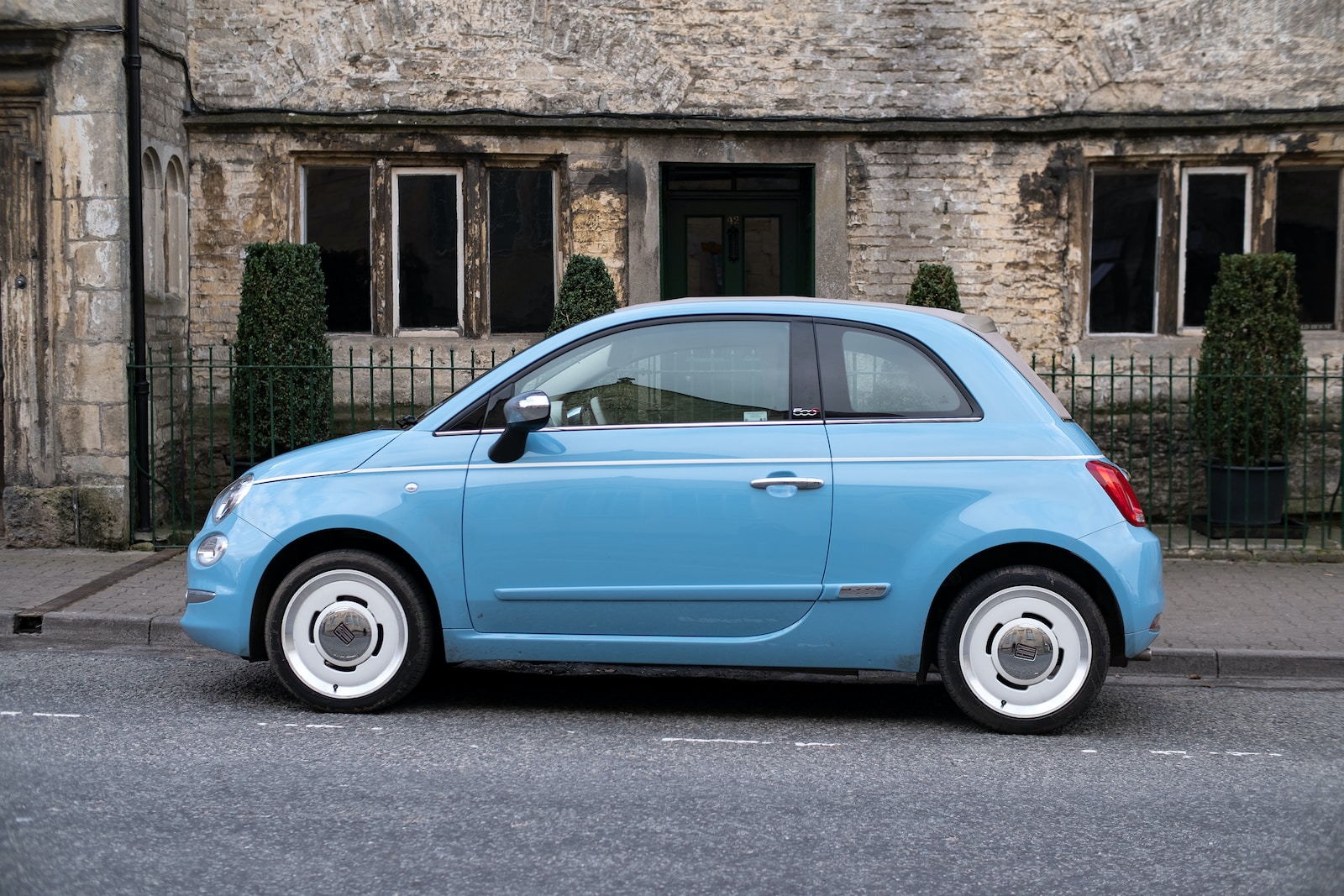 teal 3-door hatchback on road