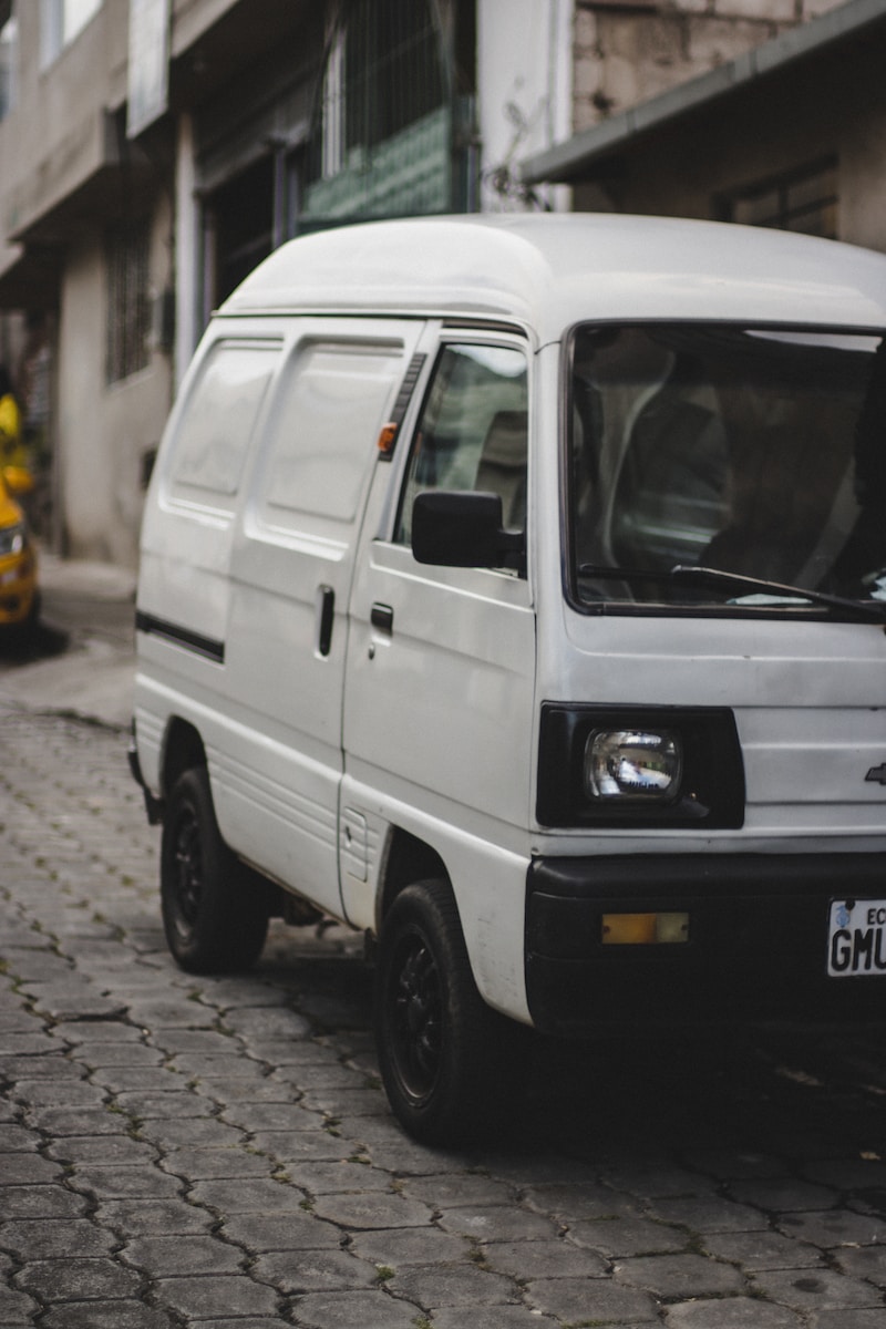 a white van parked on a brick road