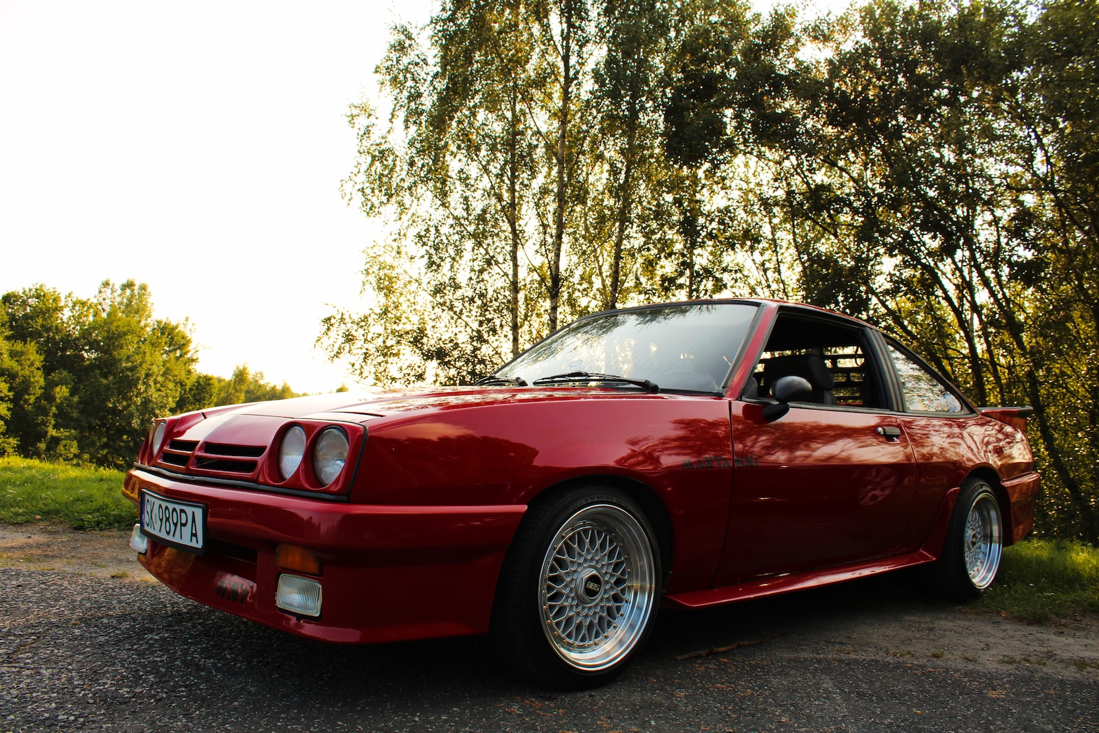 a red sports car parked on the side of the road