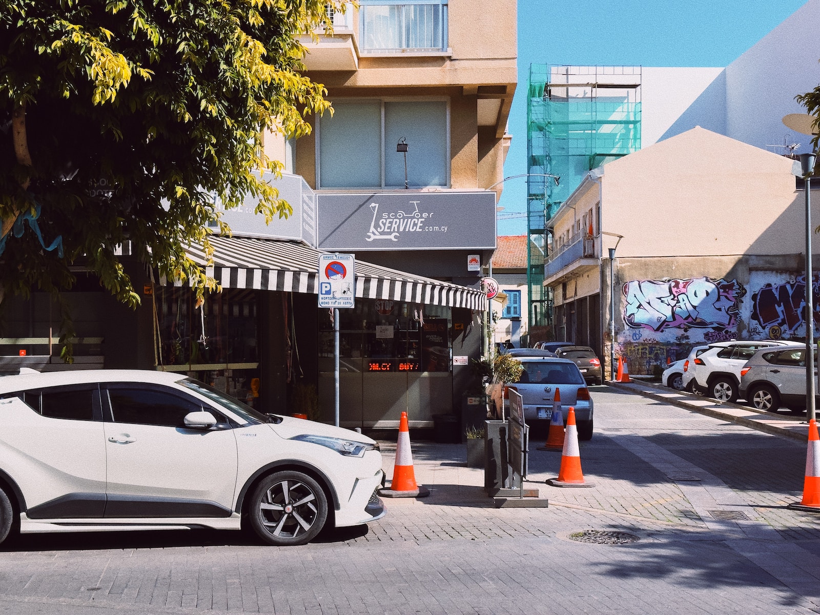 a white car parked on the side of a road