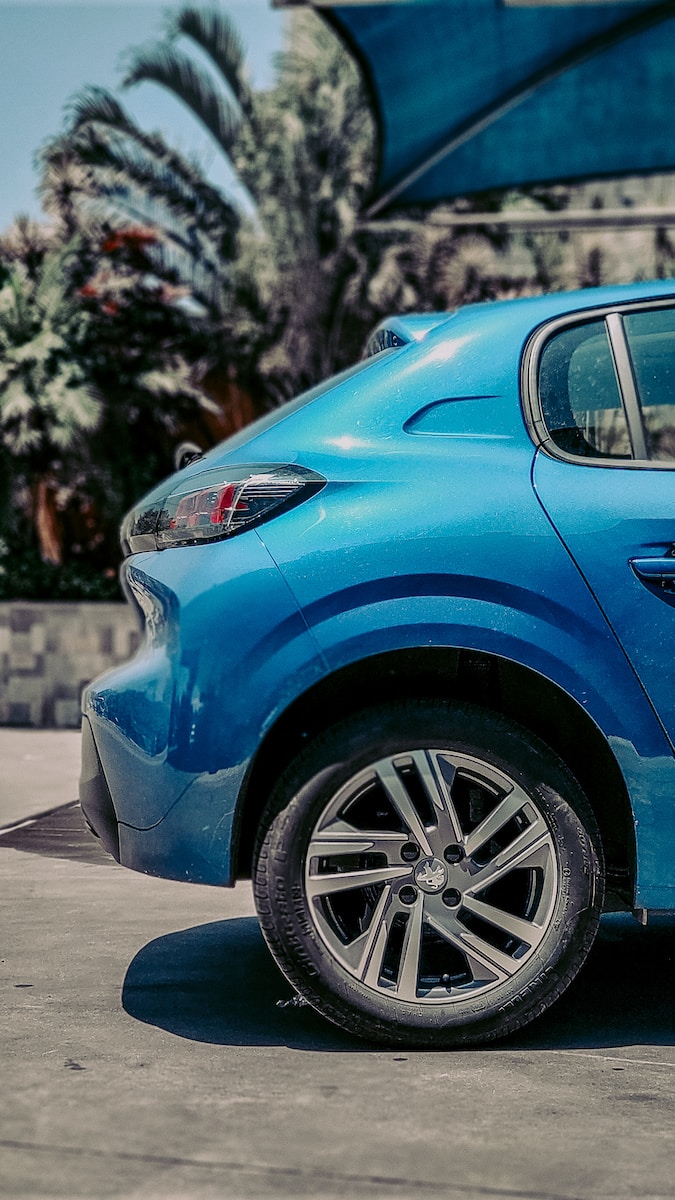 a blue car parked in front of a building