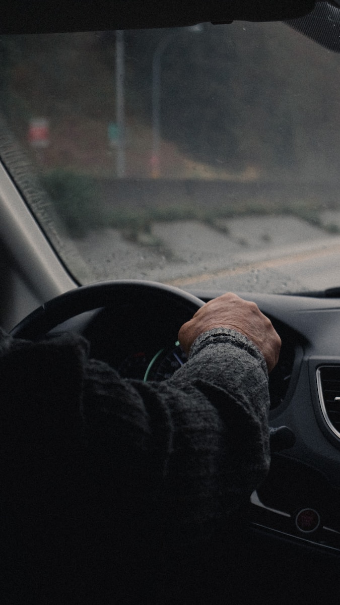 a person driving a car on a rainy day