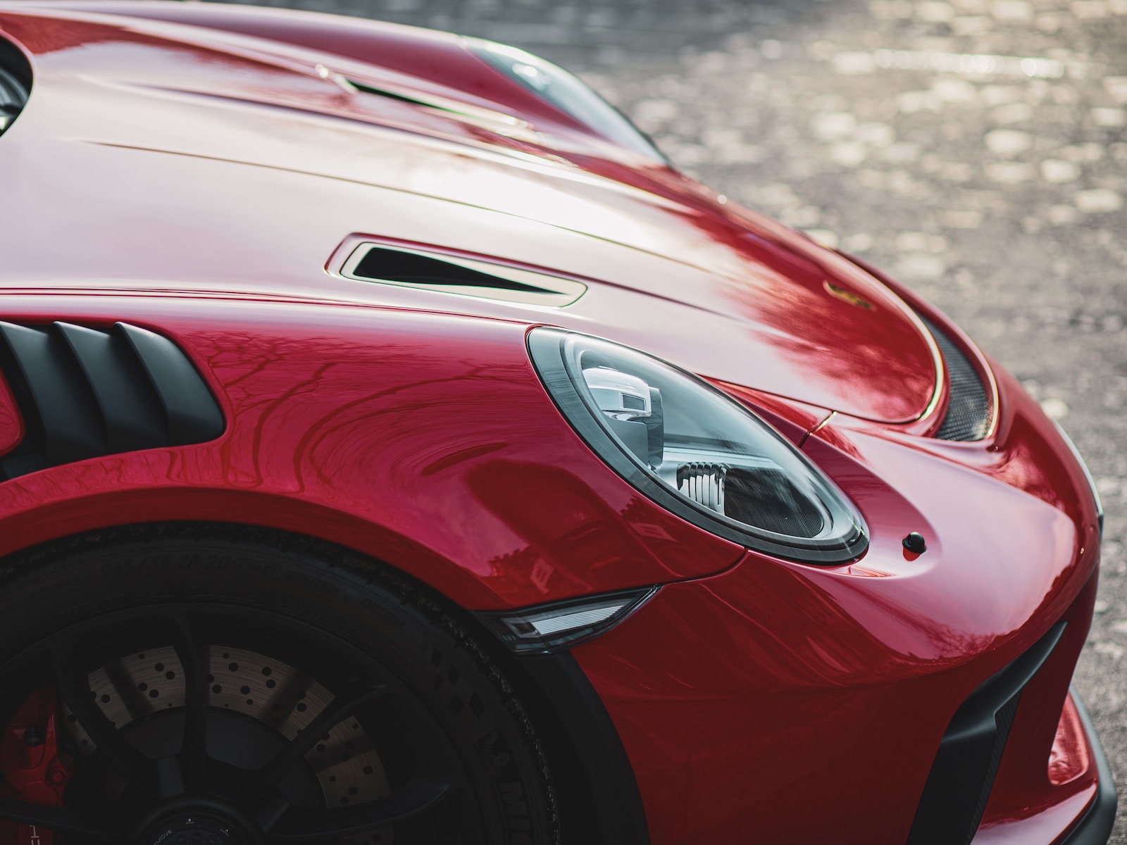 a red sports car parked on the side of the road