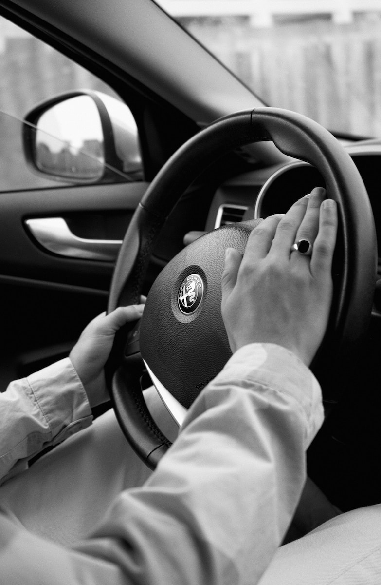 person holding steering wheel