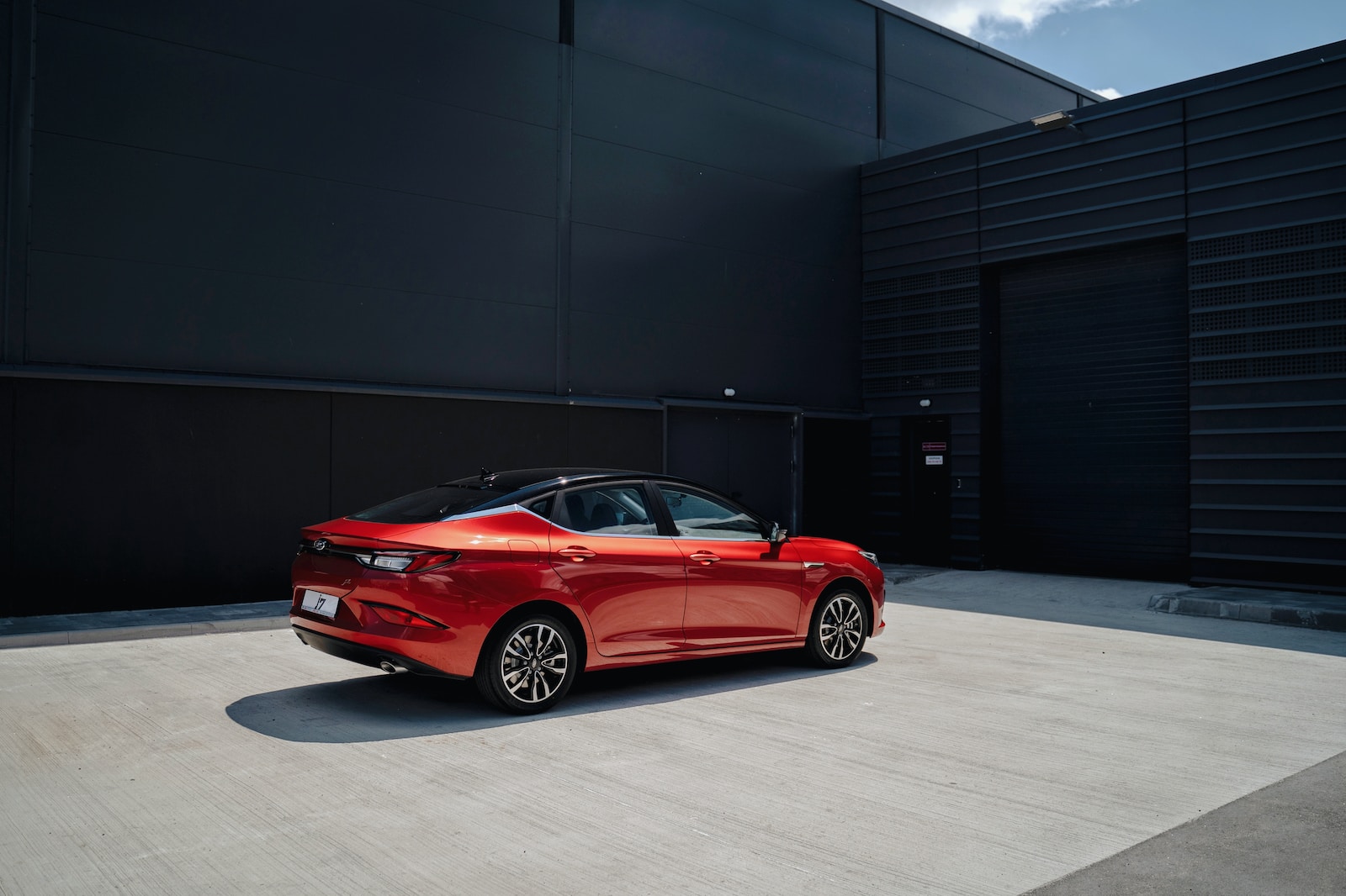 a red car parked in front of a building