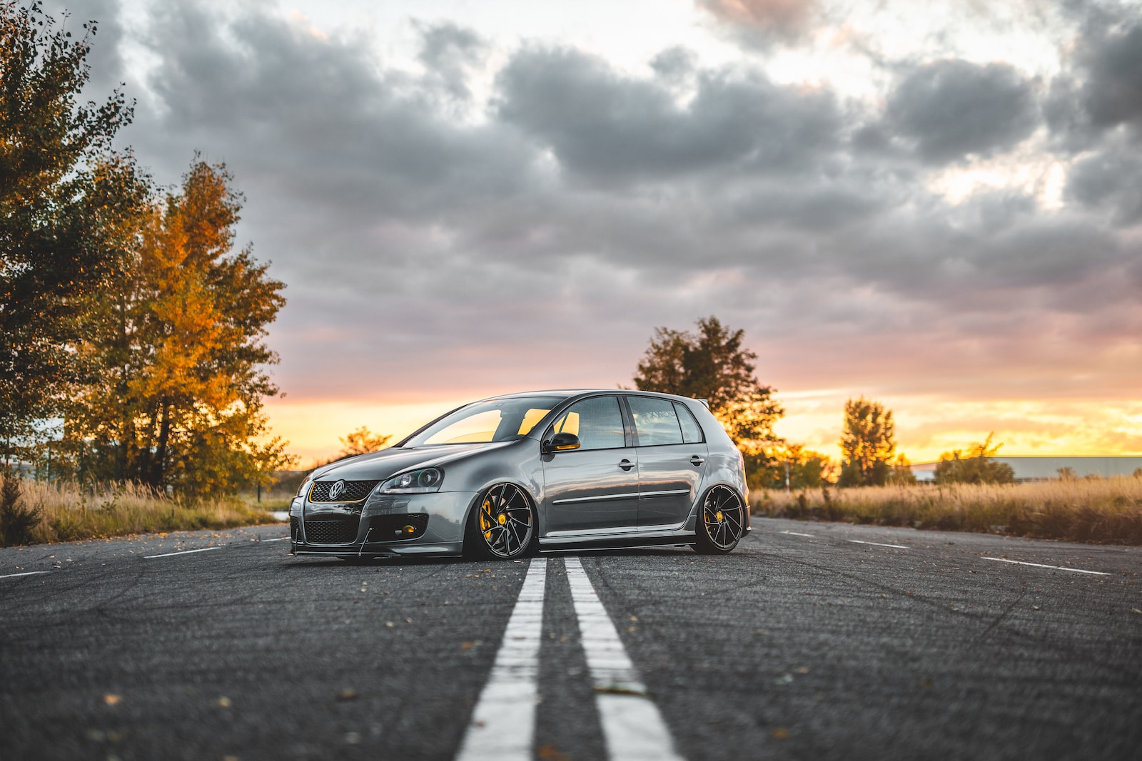 silver 5-door hatchback parked in the middle of the road during day