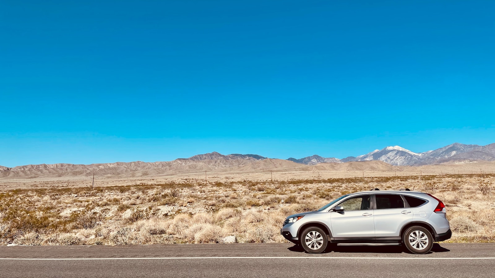 silver sedan on road during daytime