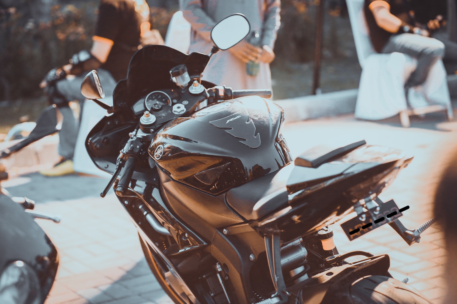 black and brown motorcycle parked on the street during daytime