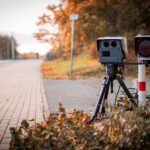 black and gray camera on tripod on road during daytime