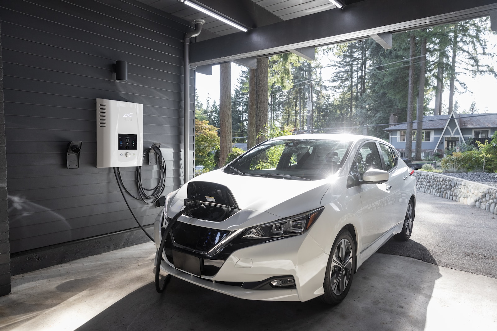 a white car plugged in to a charging station