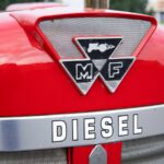 a close up of the emblem on the front of a red tractor