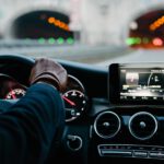 person inside vehicle holding steering wheel