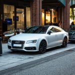 silver Audi sedan parked on street beside restore